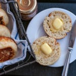 Homemade English Muffins opened in half and served with butter