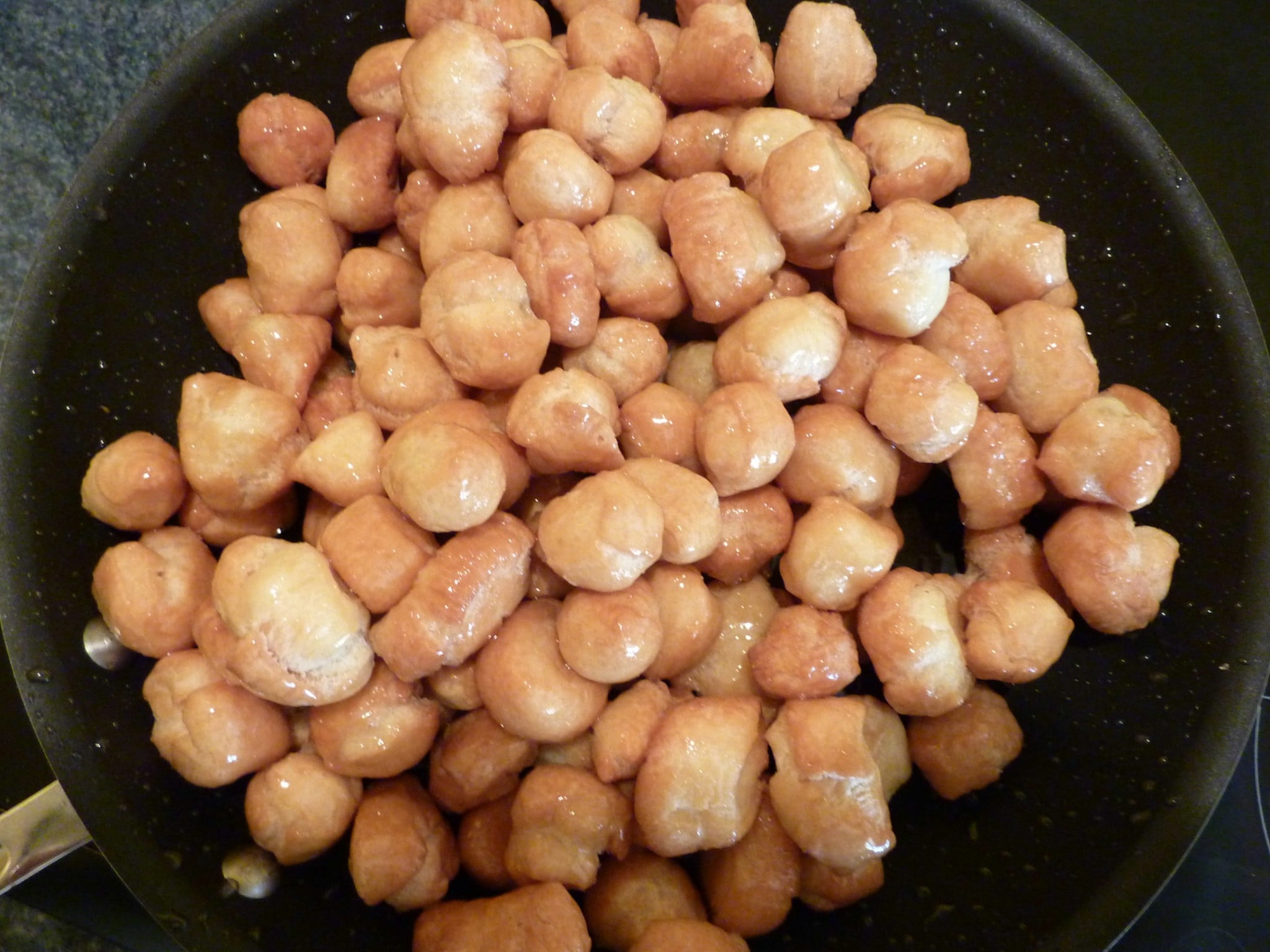Struffoli in a pan with honey