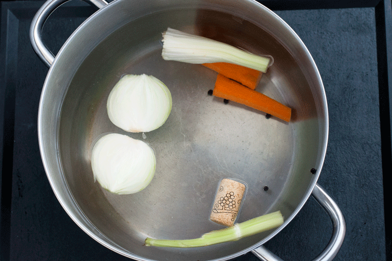 Boiling the octopus in a pot with a wine cork