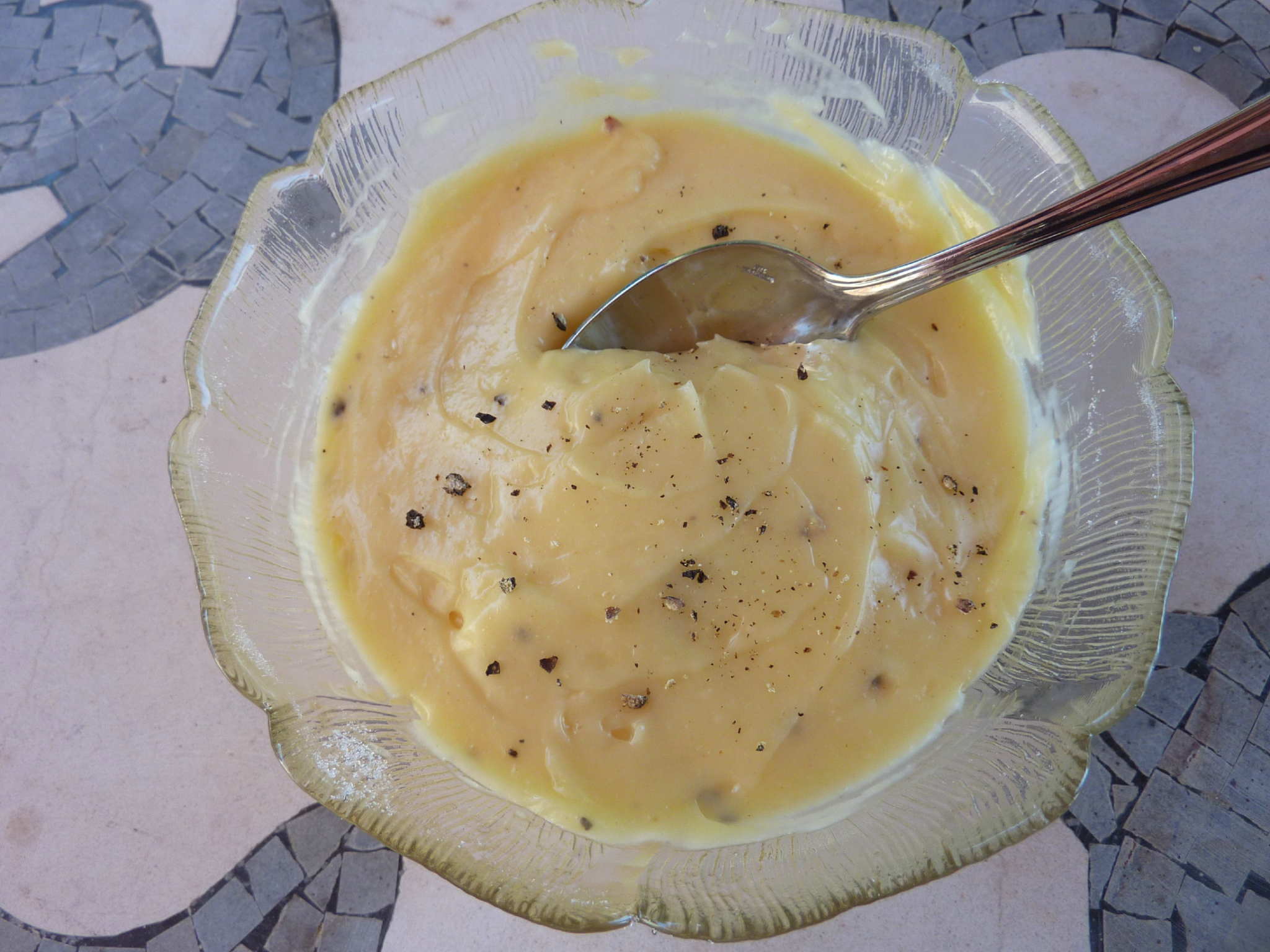 Homemade mayonnaise in a bowl with a spoon
