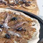 Pissaladiere Nicoise is dish sold in many bakeries as a starter or snack. It is a pizza base topped by Mediterranean onions, anchovies and olives. #yourguardianchef #frenchfood #pizza
