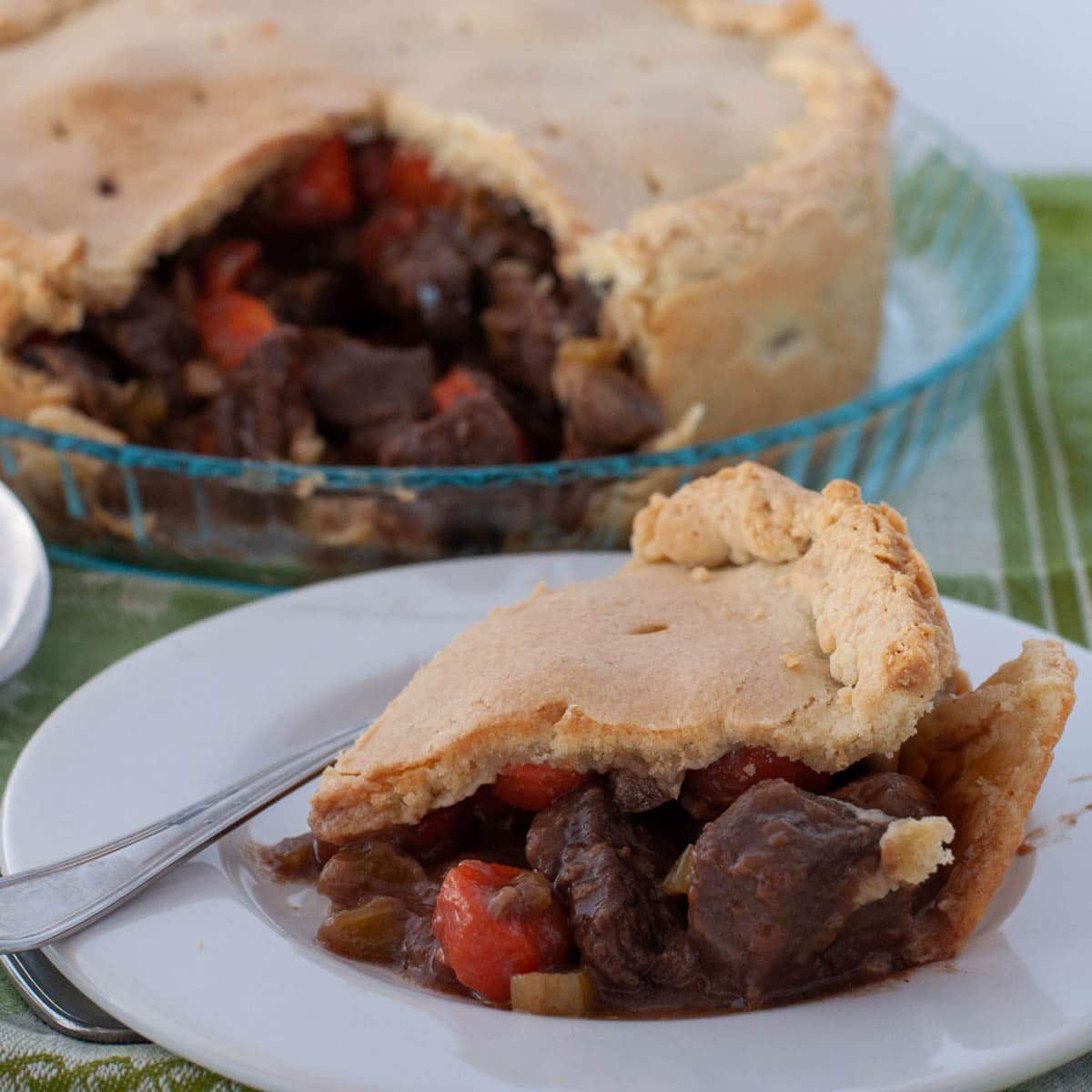 Beef Marsala pie with a slice cut on a plate