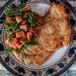 Veal Milanese is a fried breaded veal cutlet, a typical recipe from Milan usually served with an arugula salad and/or french fries. Some restaurants in Milan serve a huge cutlet also called Elephant Ear, larger than the plate in which it is served. #yourguardianchef #Italianrecipe #italianfood #veal