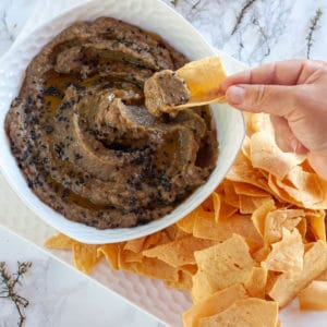 Socca chips dipping into eggplant caviar