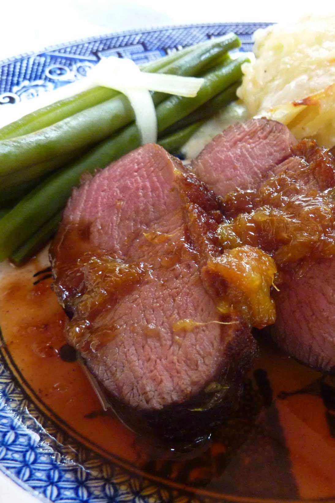 Magret de Canard served on a plate with green beans and potatoes
