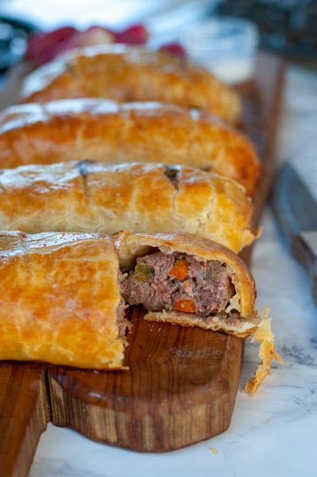 Beef sausage hand pie recipe on a cutting board