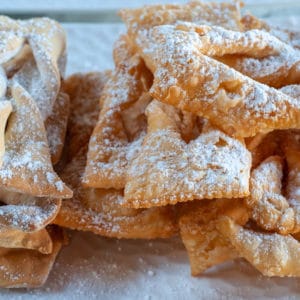 Orelliettes Chiacchiere on a serving dish dusted with icing sugar
