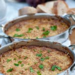 This hot artichoke dip has a crusty top and a creamy centre. An artichoke appetizer with parmesan and garlic, it is very easy to make and perfect for dinner parties as it can be prepared in advance and just put in the oven 30 minutes before serving.