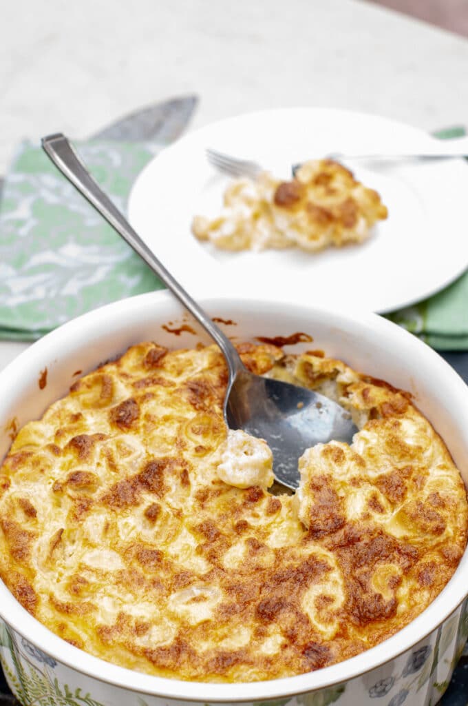Baked tortellini souffle with a spoon serving it