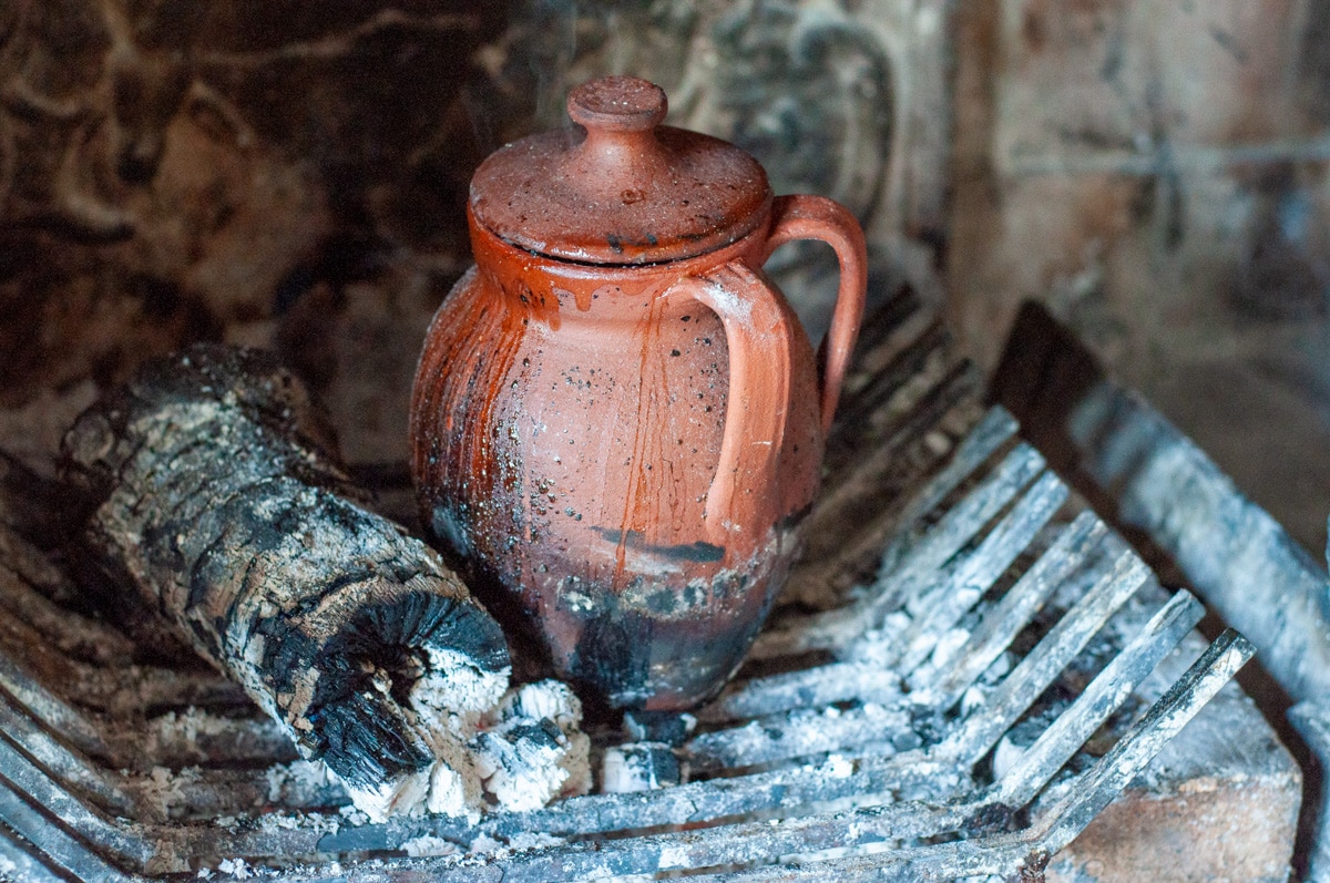 pot cooking next to the fire