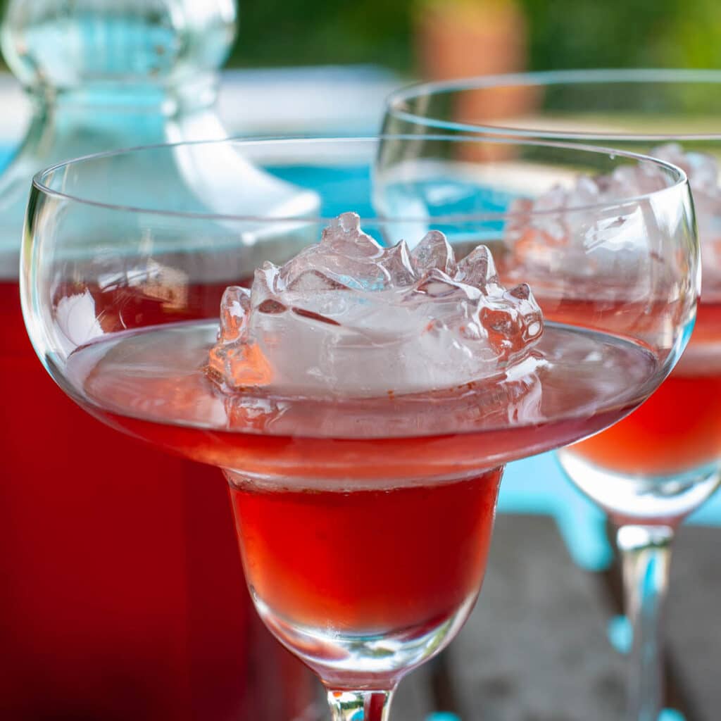 homemade strawberry liqueur in a glass served with ice