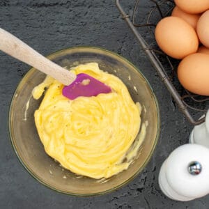 homemade mayonnaise in a bowl eggs in a corner