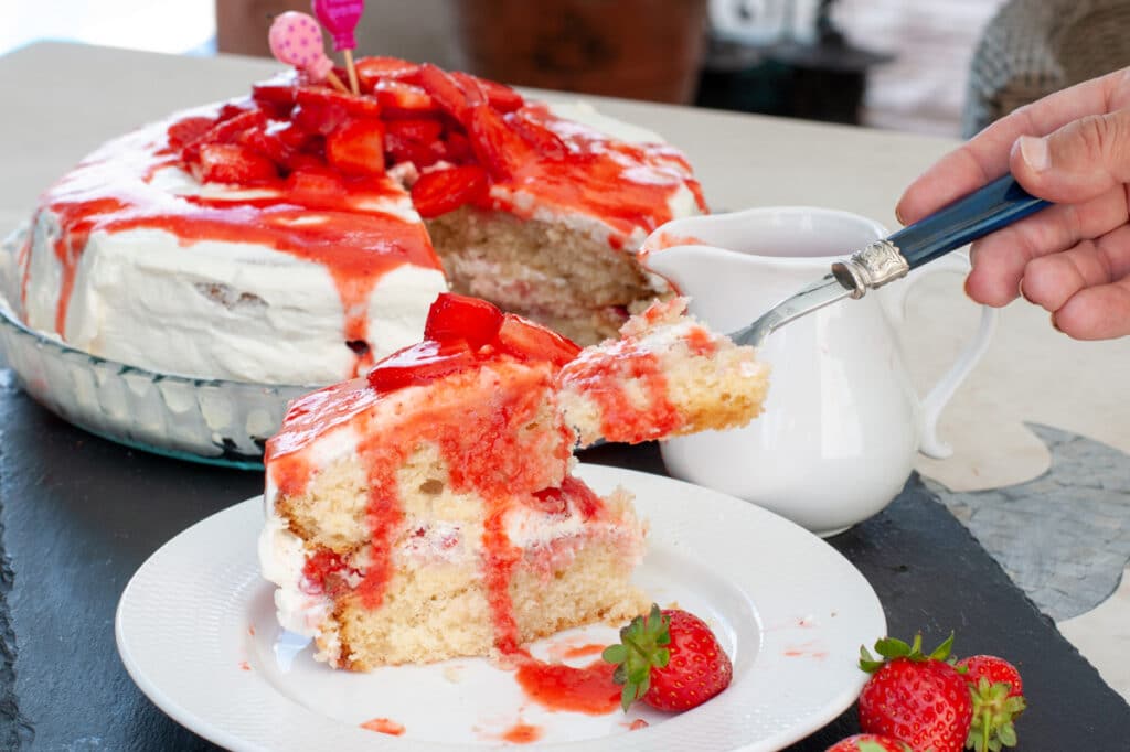 a slice of strawberry shortcake served on a plate