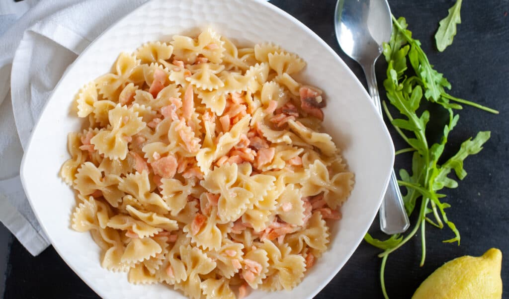 Pasta bow tie with smoked salmon on a plate