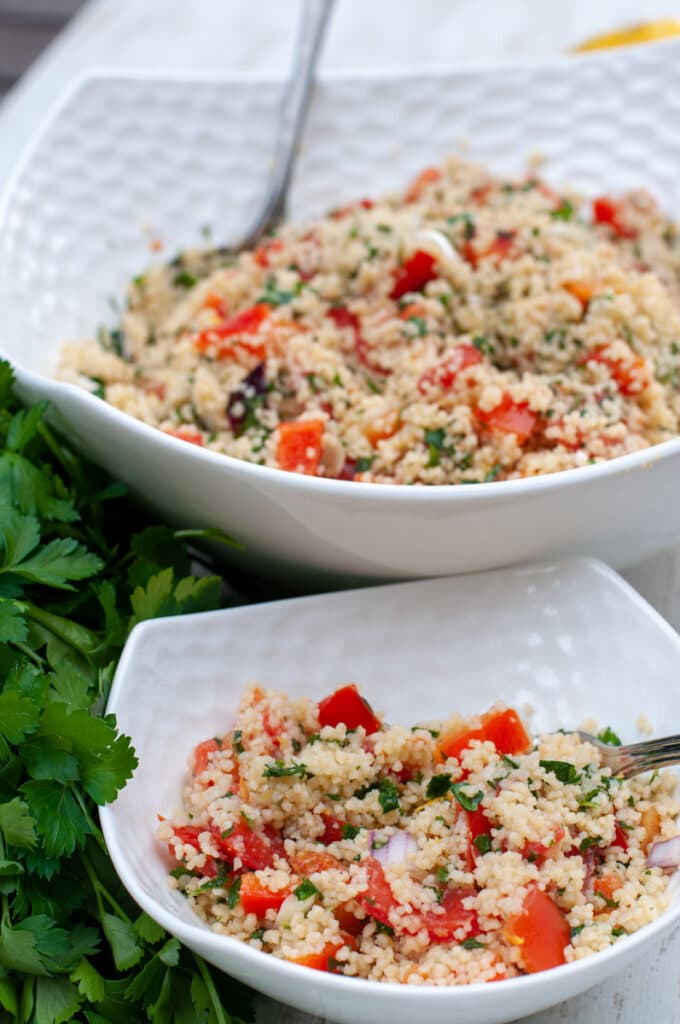 Tabbouleh served in a bowl with parsley on the side