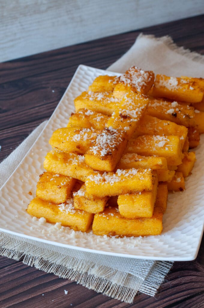 Fired polenta sticks sprinkled with Parmesan cheese