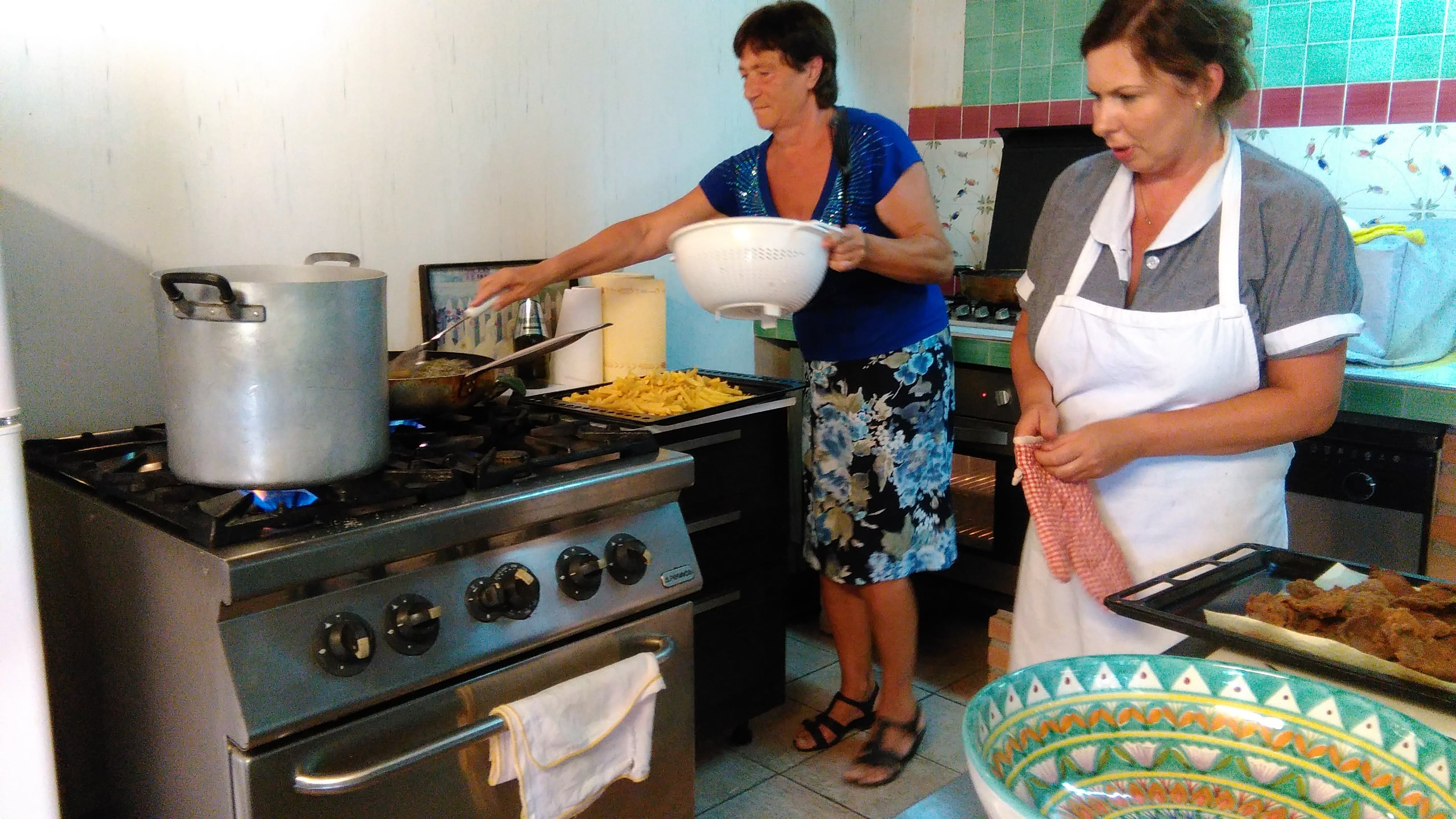 my cousin Domenico summer kitchen with the ladies cooking cotolette for our children