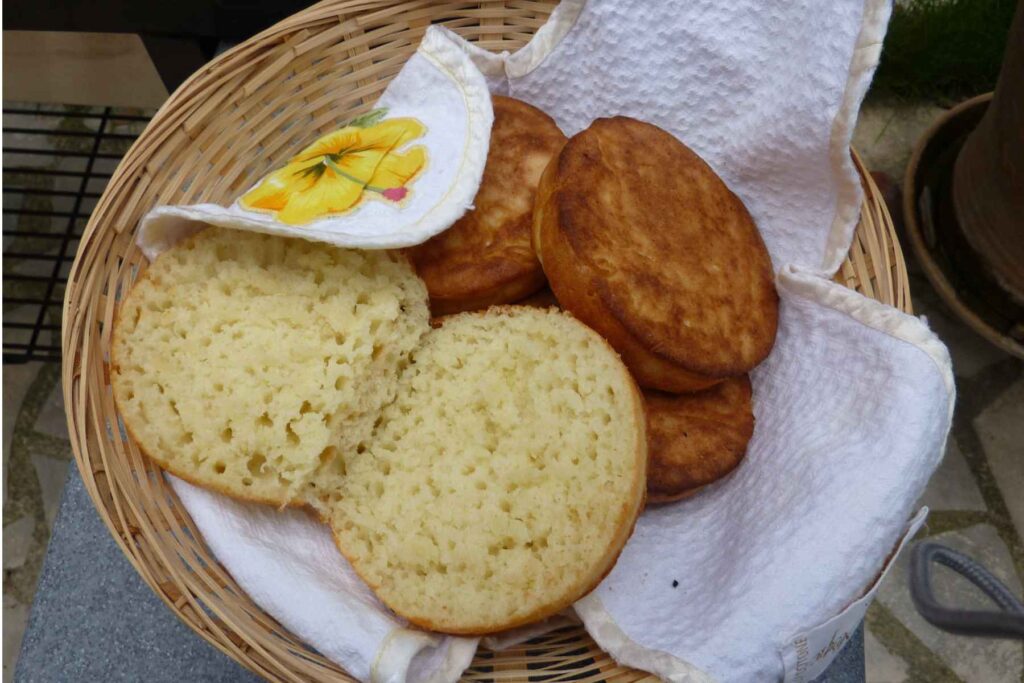 homemade english muffins in a basket