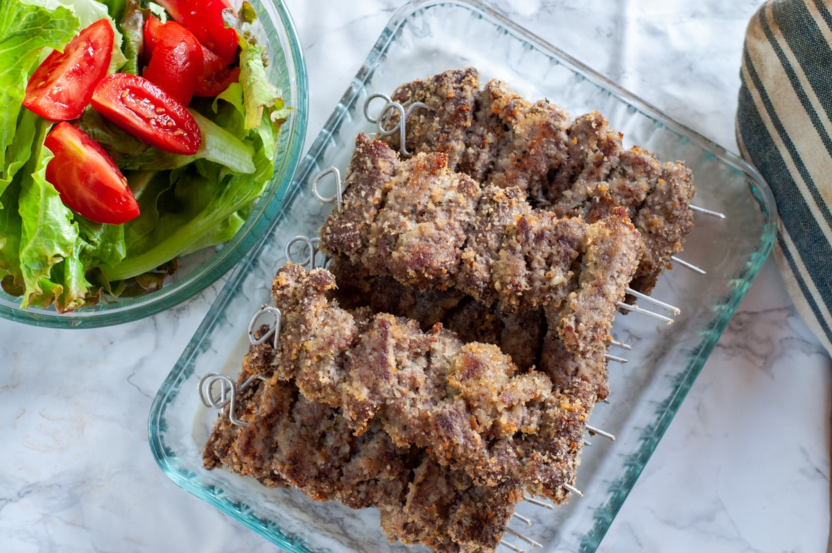 beef spiedini served with a salad