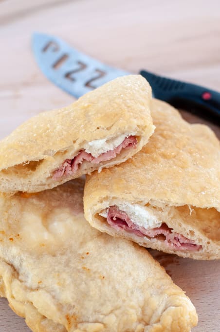 Panzerotti cut in half filled with rocotta and ham