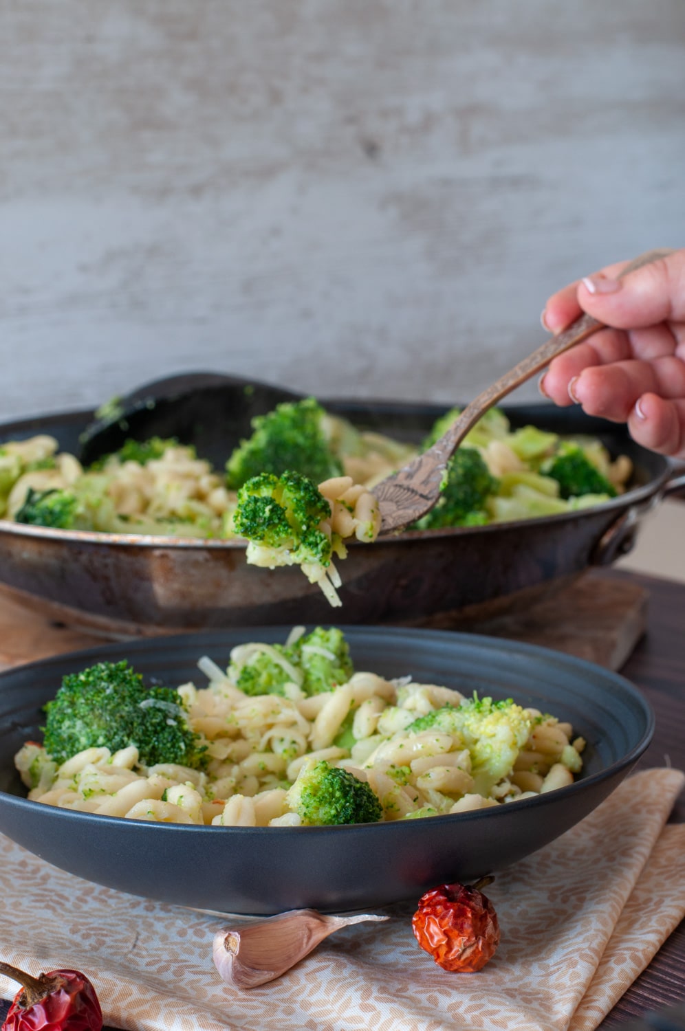 Cavatelli and broccoli served on a plate and a fork lifting a bite