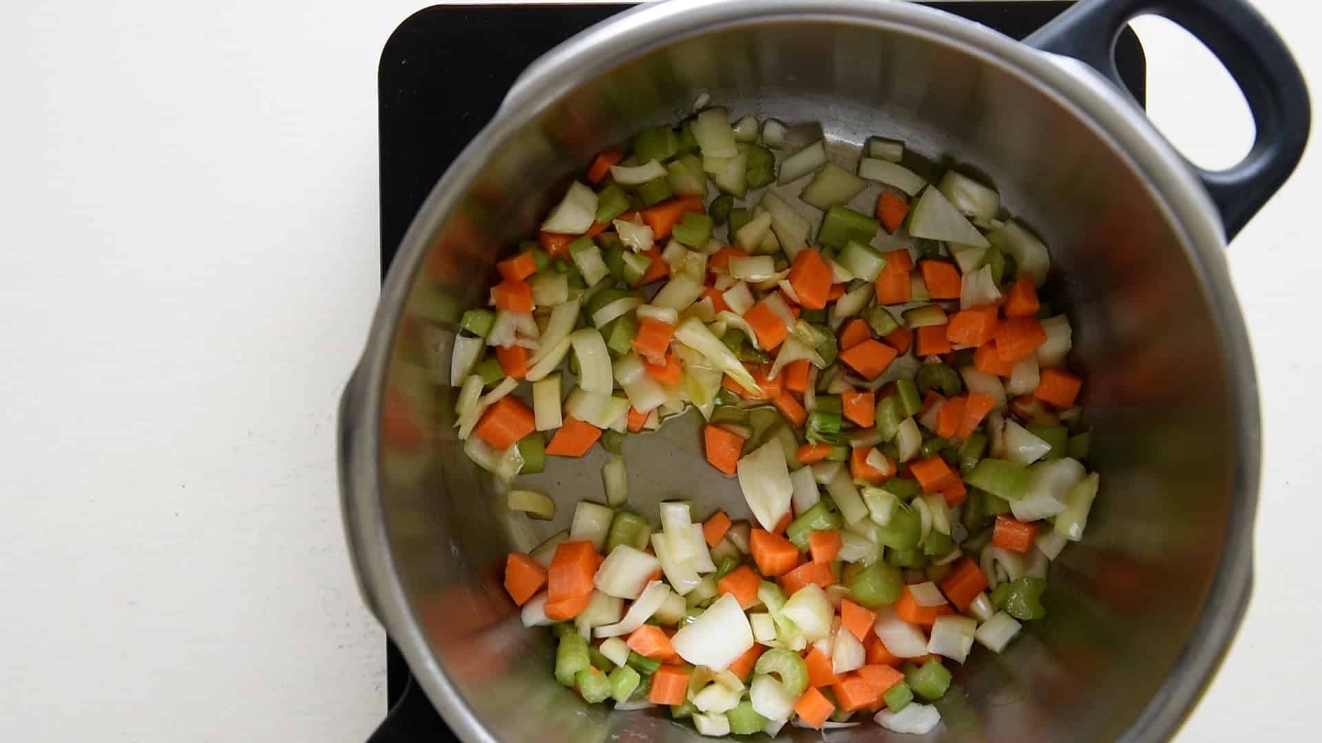 stir frying onion, carrot and celery