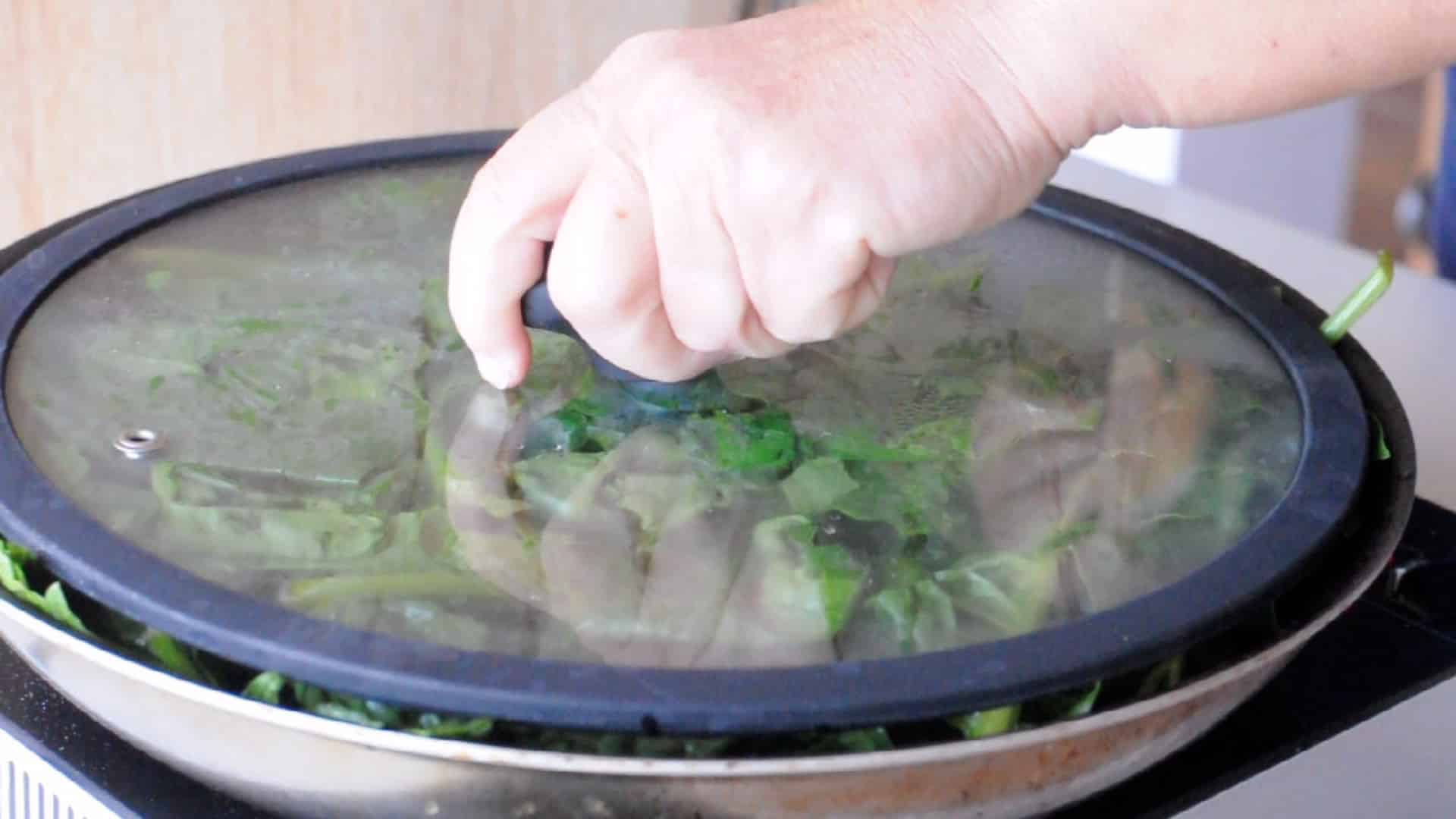 Spinach in a pan covered with a lid