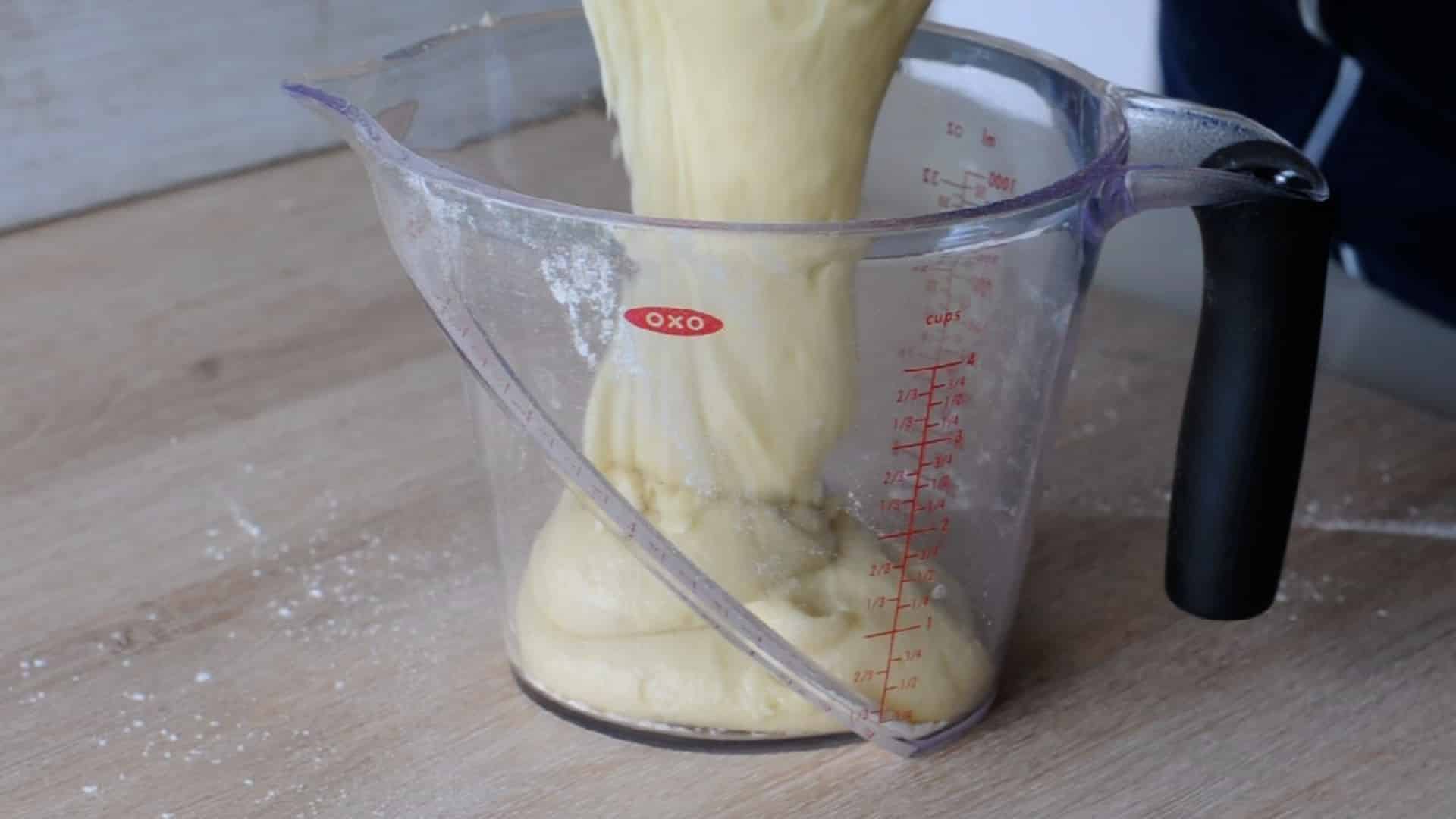 Pouring half batter in a measuring bowl