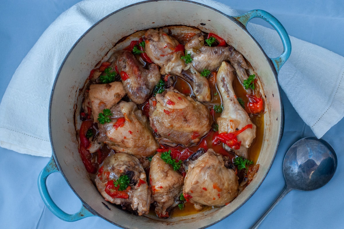 chicken with peppers in the pot decorated with parsley