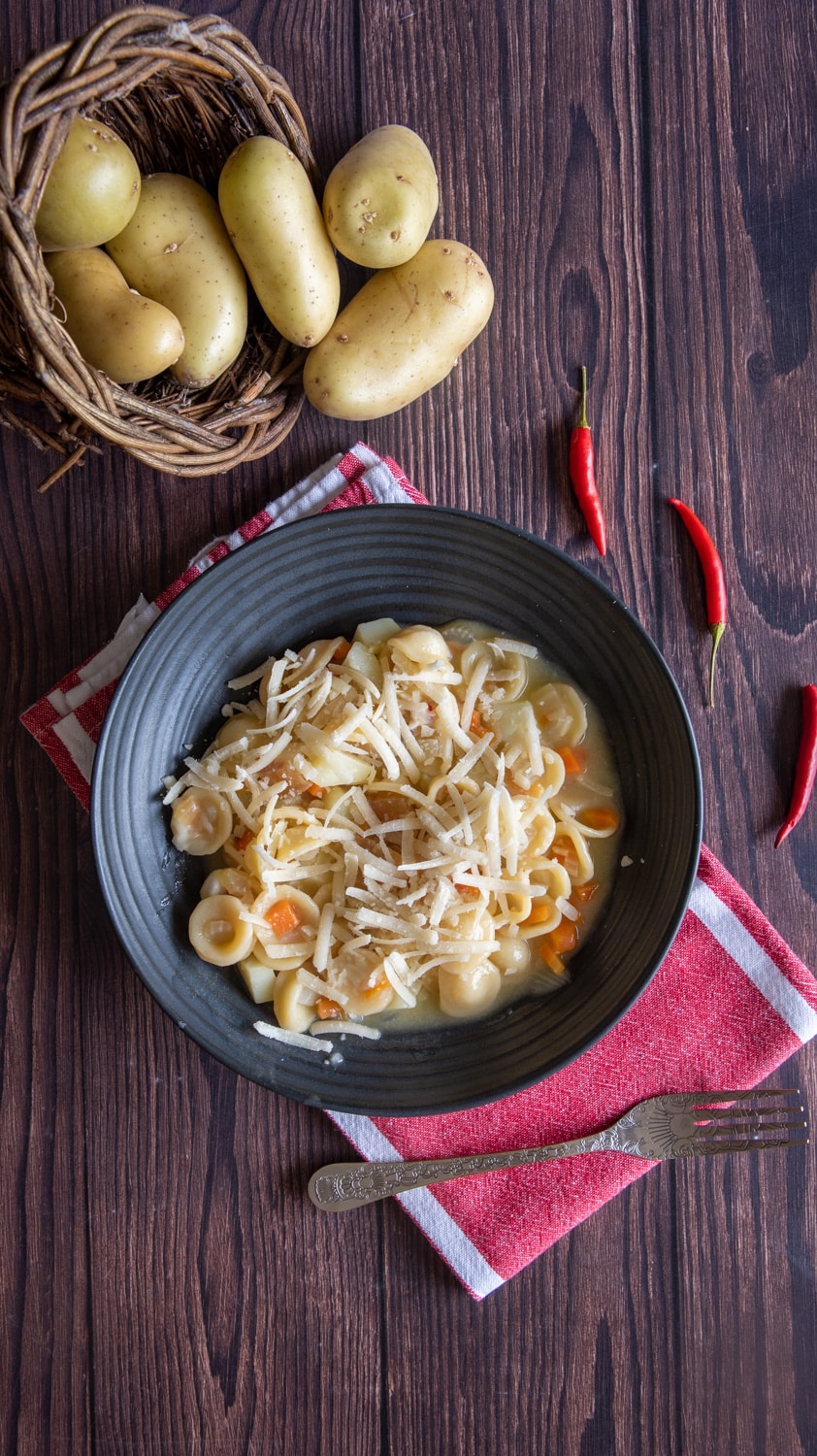 pasta and potatoes served on a plate topped with Parmesan