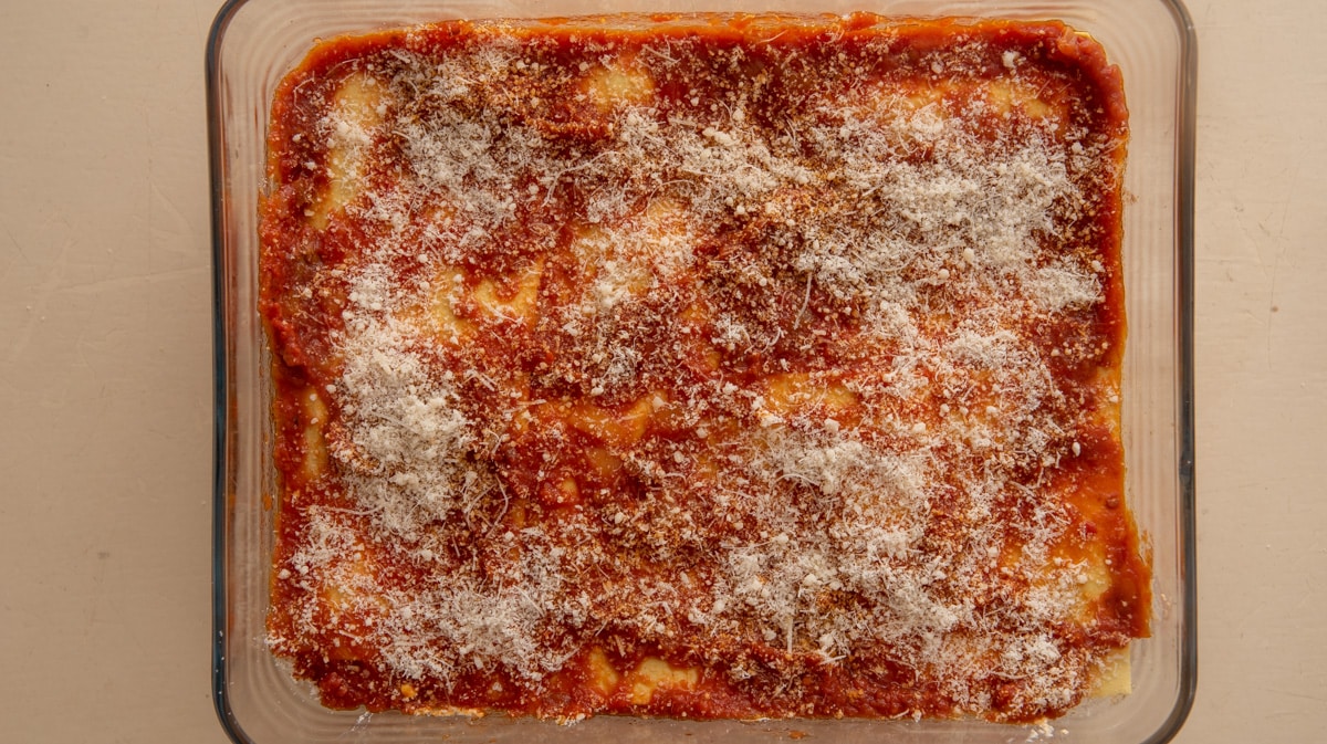On the top layer, pour the remaining sauce and sprinkle with Parmesan cheese