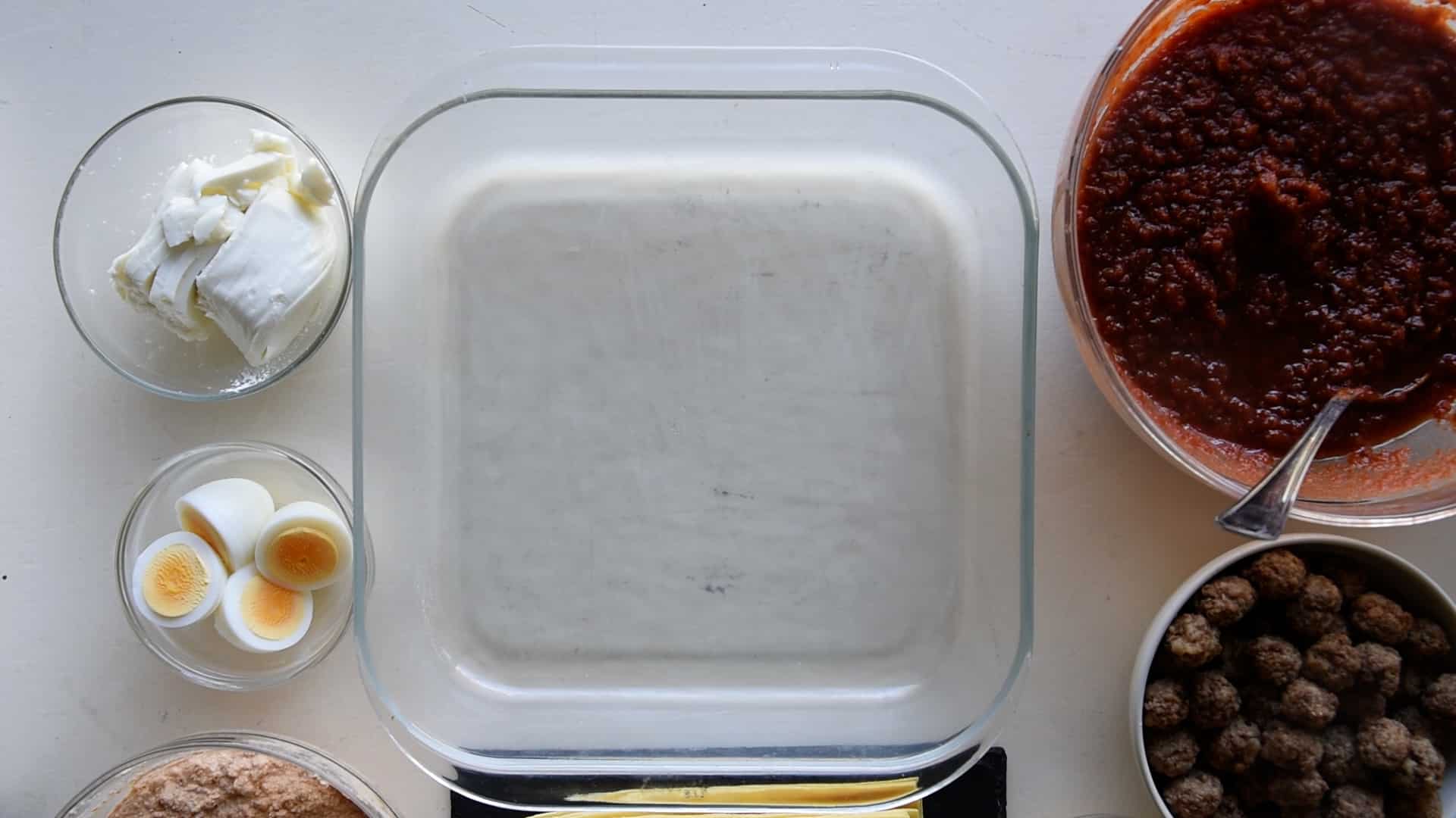 Place all the ingredients around the lasagna baking dish