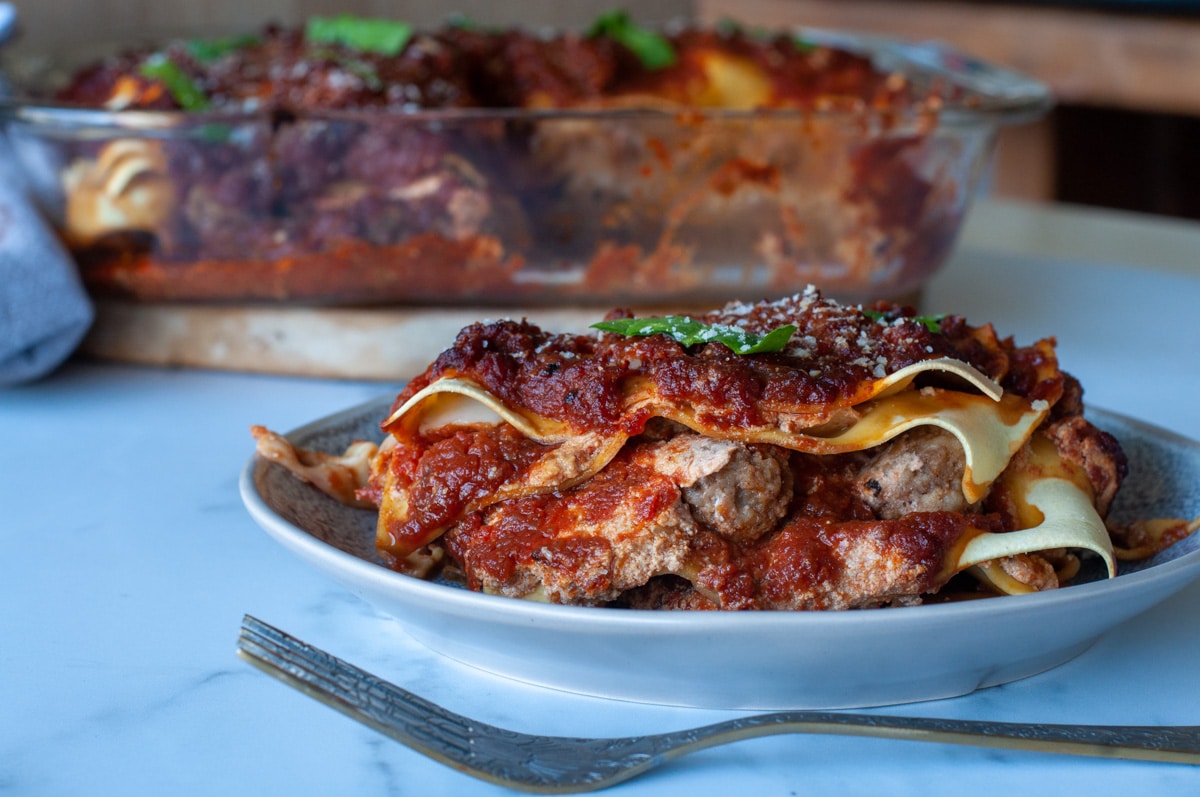 Southern lasagna served on a plate showing the meatballs inside