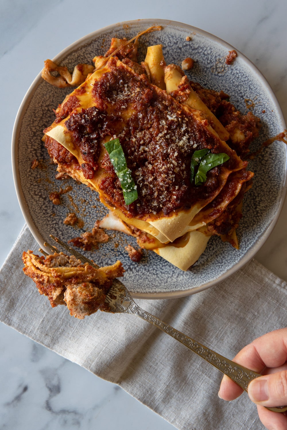 lasagna served on a plate with a fork 