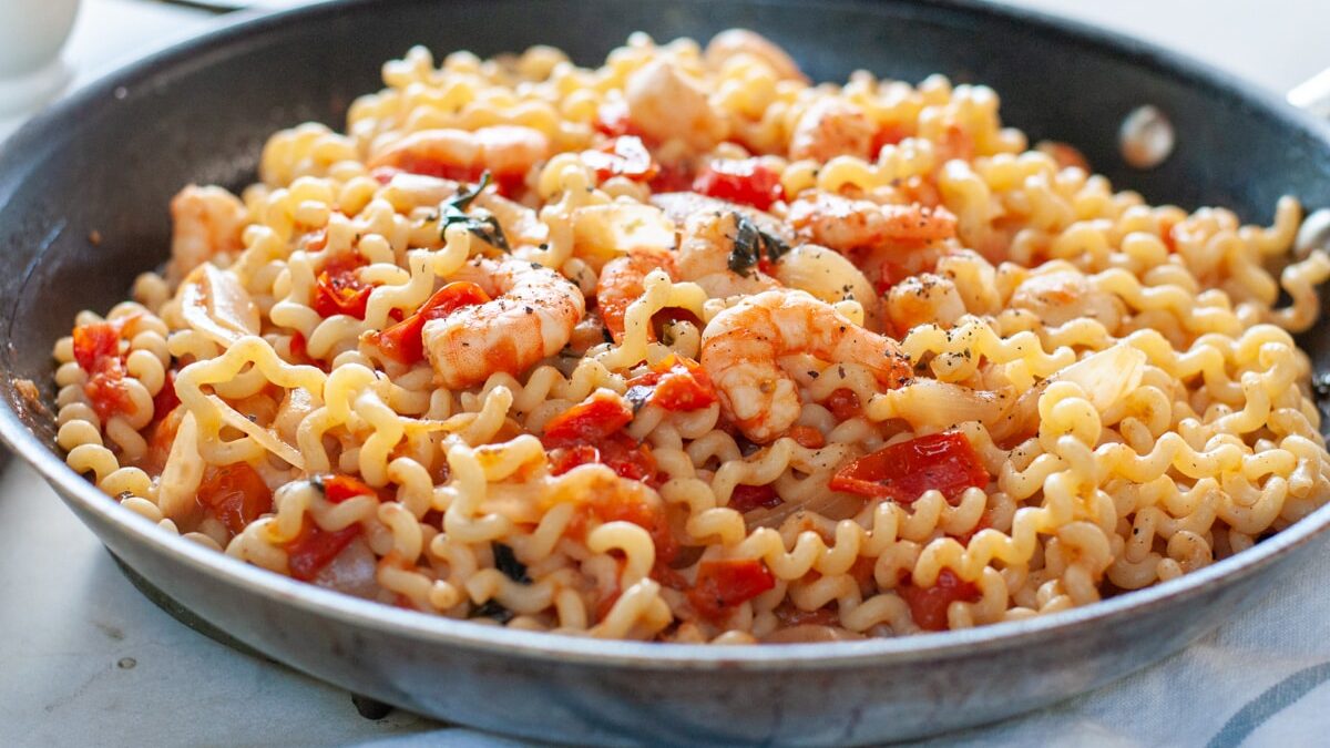 Pasta with shrimp and cherry tomatoes in a pan