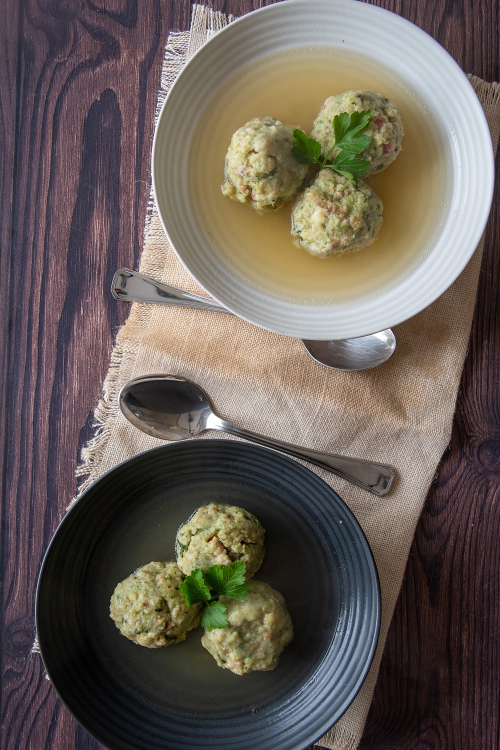 Bread dumplins canederli served in two plates with chicken broth