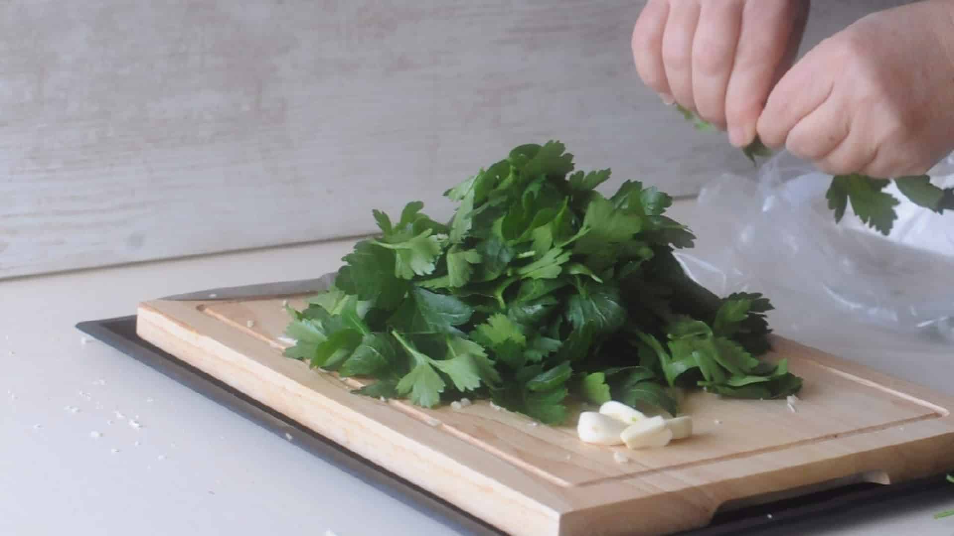 Wash and dry the fresh basil or parsley leaves and remove the stems