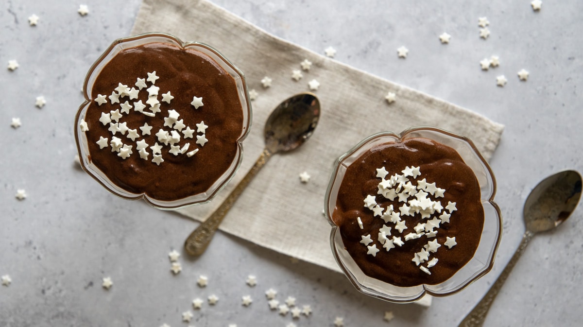 2-Ingredient Dark Chocolate Mousse decorated with sugar stars a spoon taking a bite
