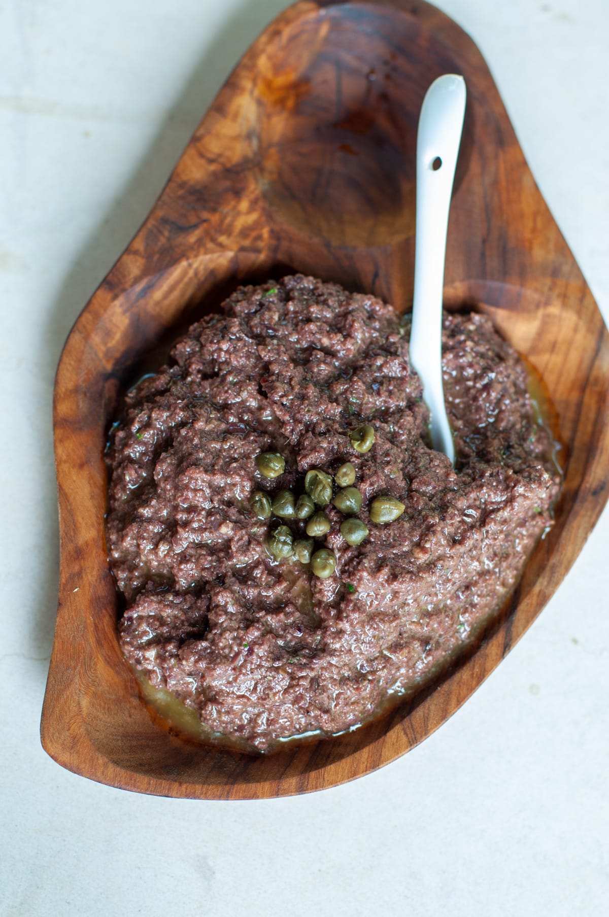 Tapenade served on a wooden bowl