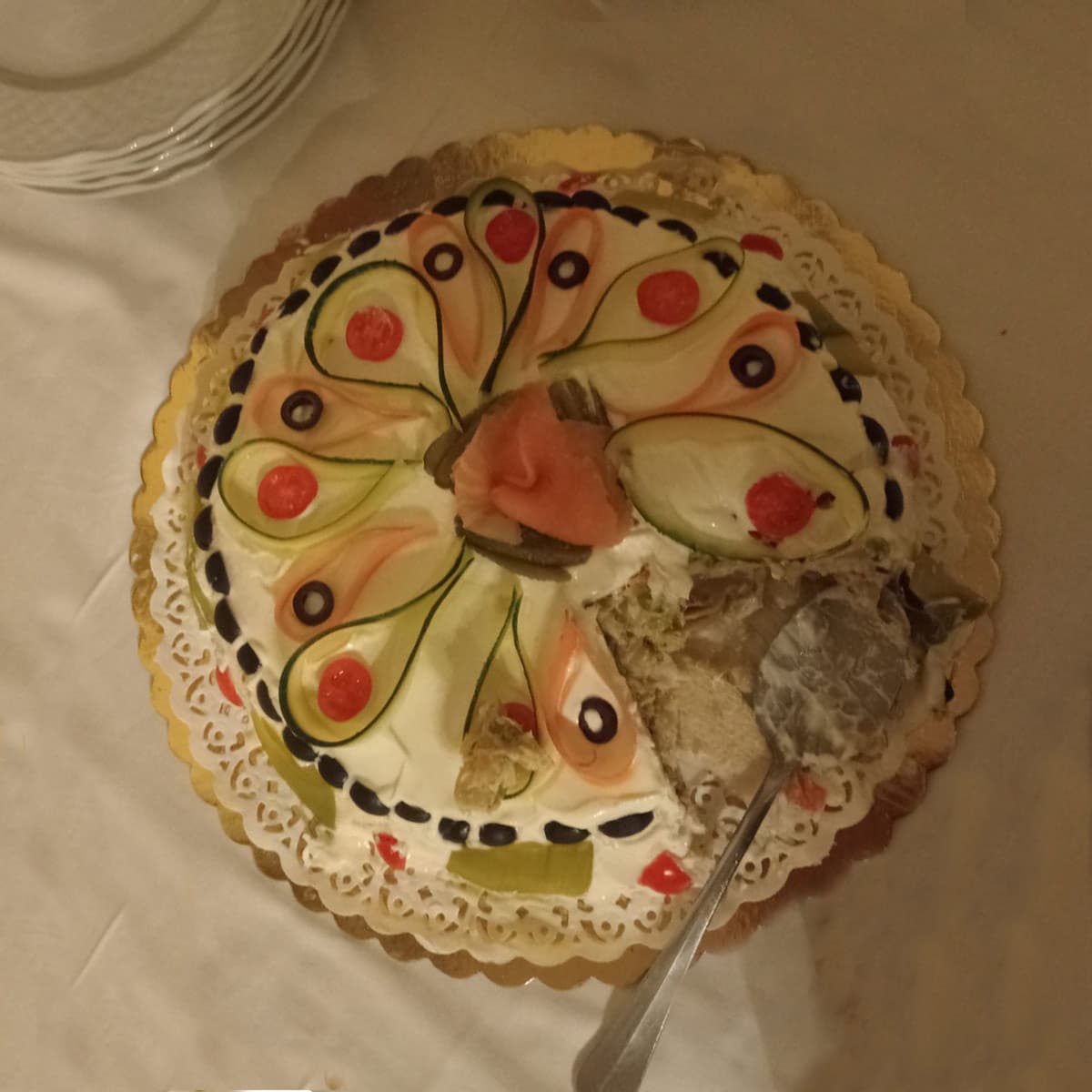 Russian salad with gelatin shaped like a cake and a slice cut