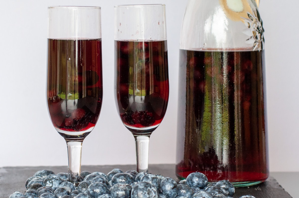 blueberry liqueur served in flute glasses with blueberries inside