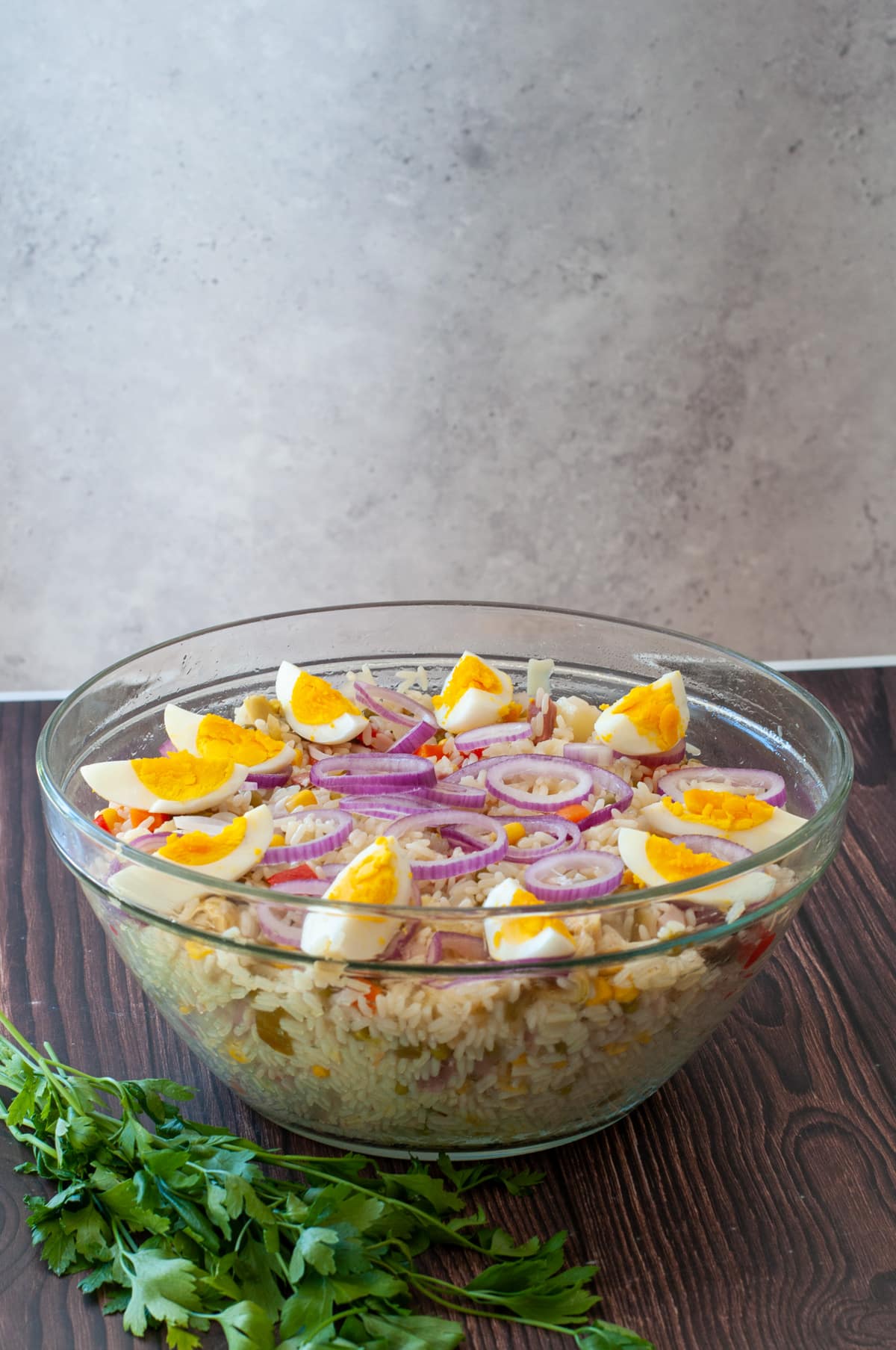 serving the rice salad in a bowl topped with boiled eggs for decoration