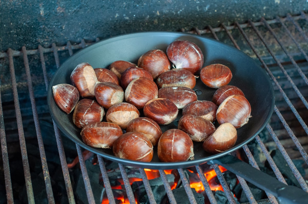 place the pan with chestnuts on the open fire