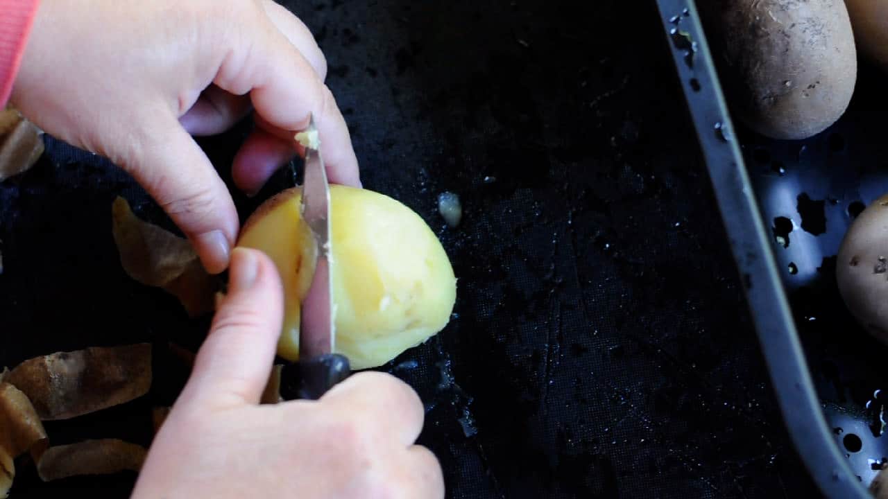 peel the potatoes while they are still war,