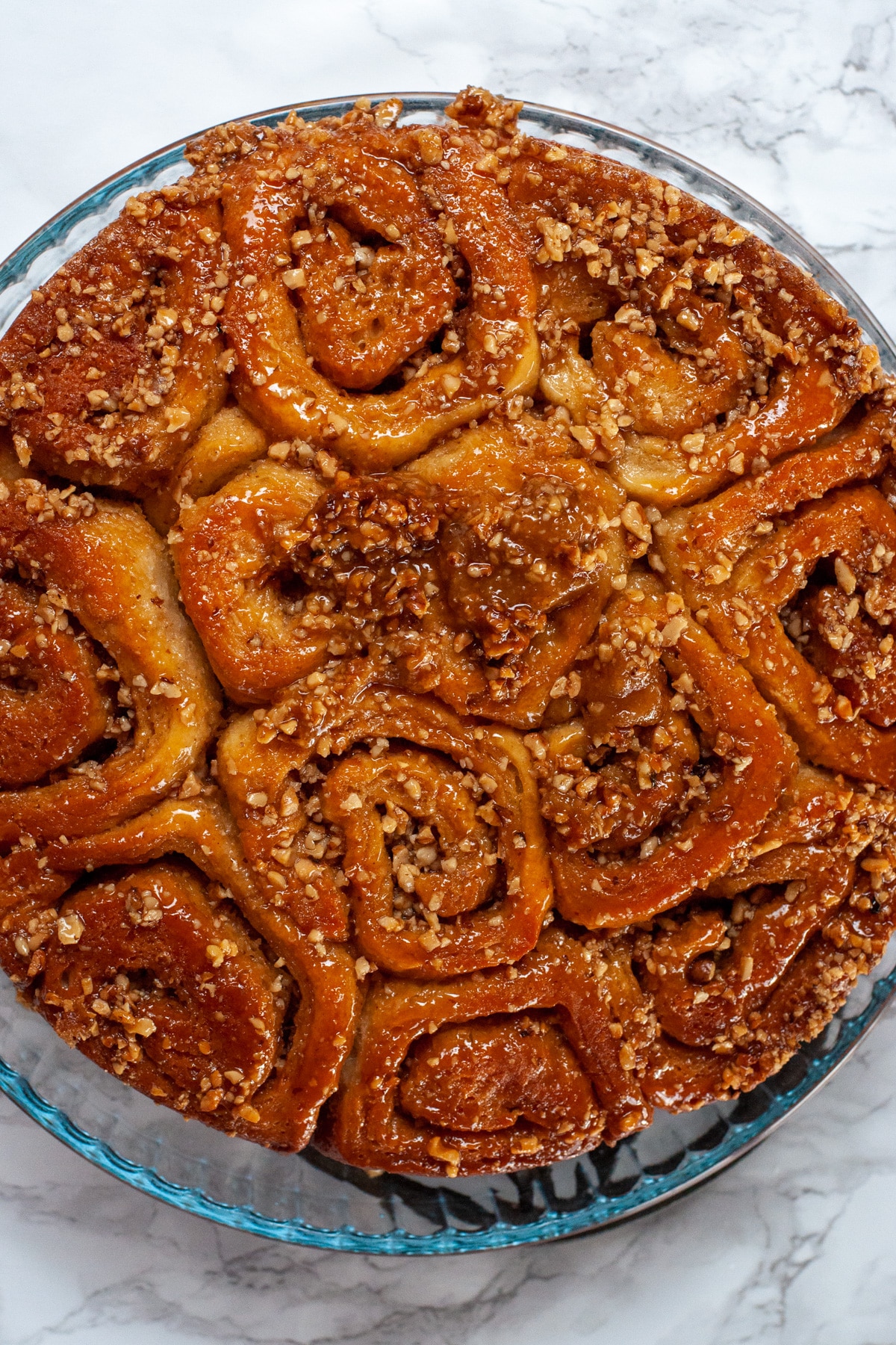 cinnamon buns topped with butter caramel and pecans