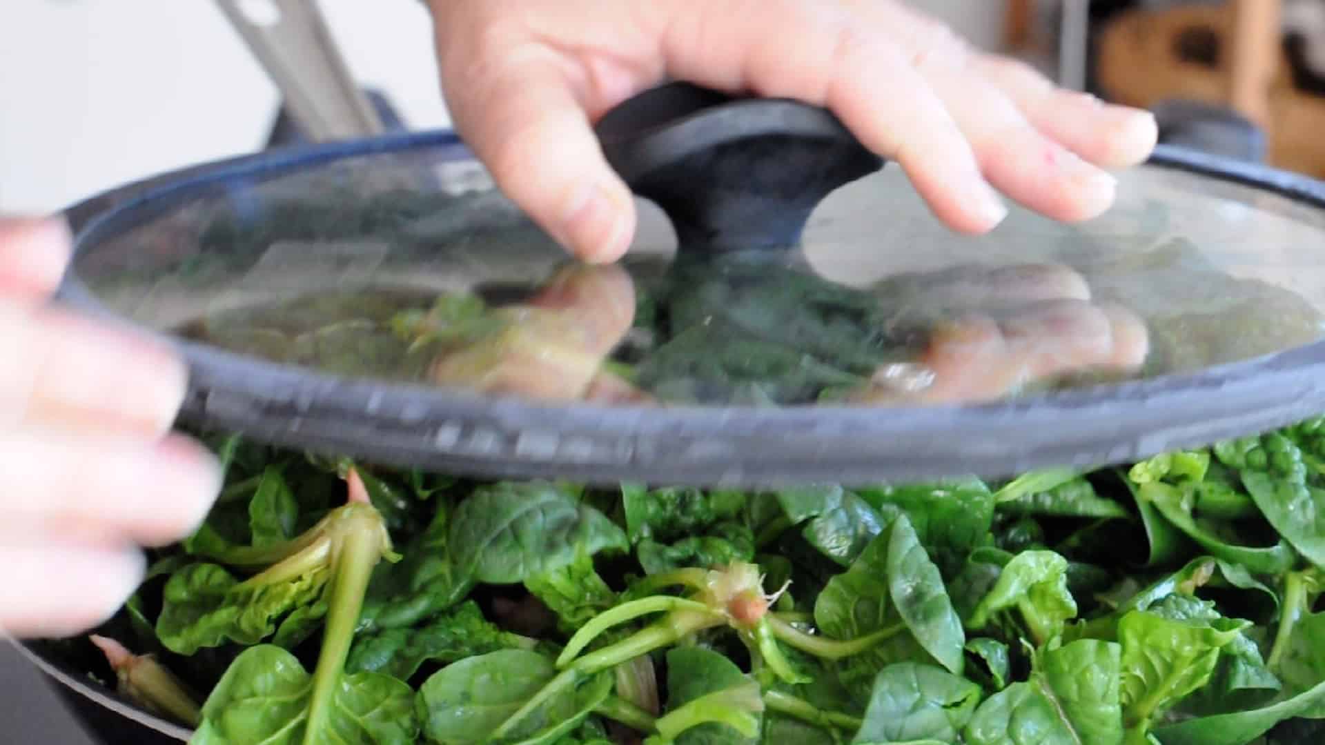 Press the lid over the spinach