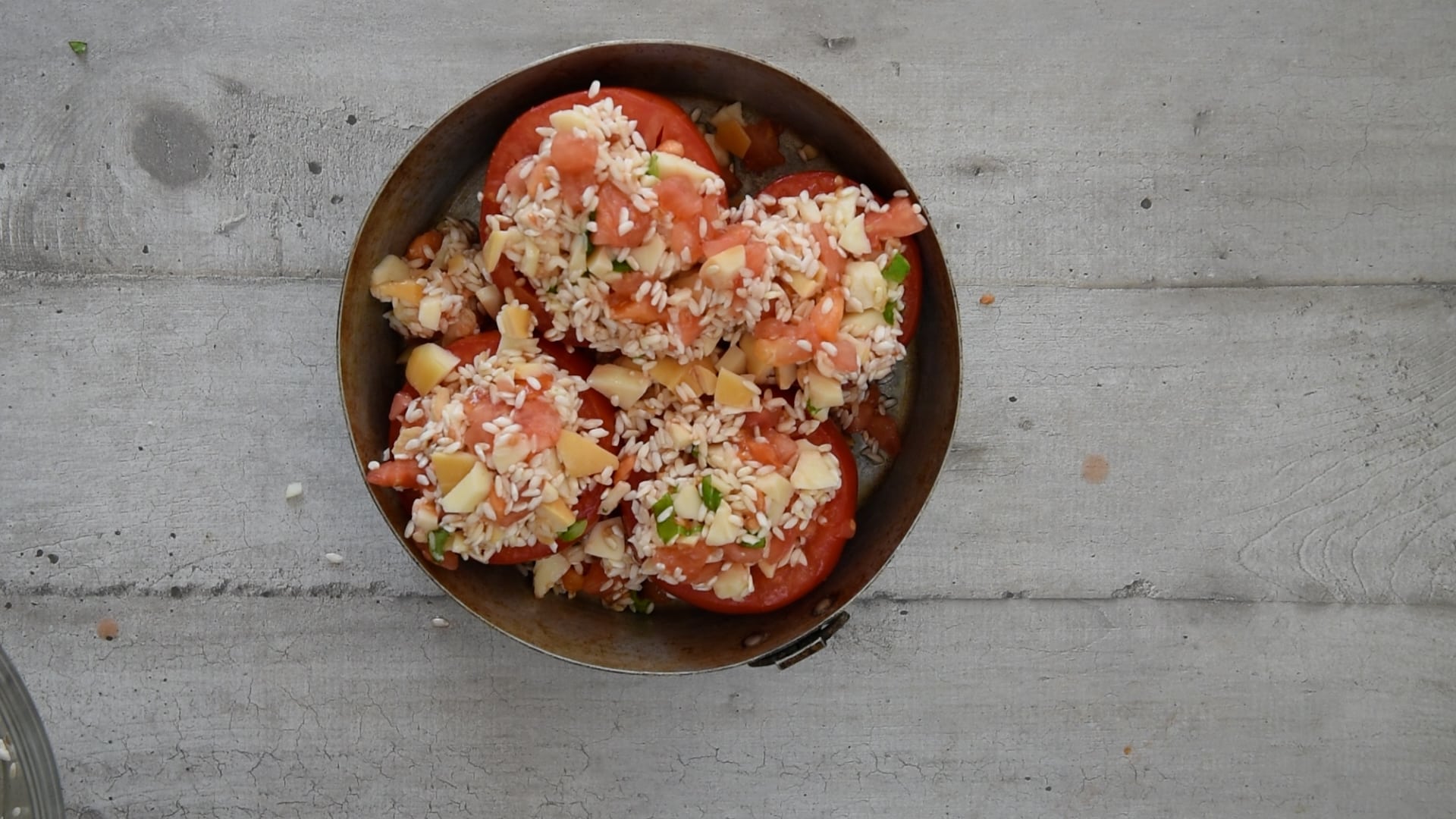 stuffing the tomatoes with rice