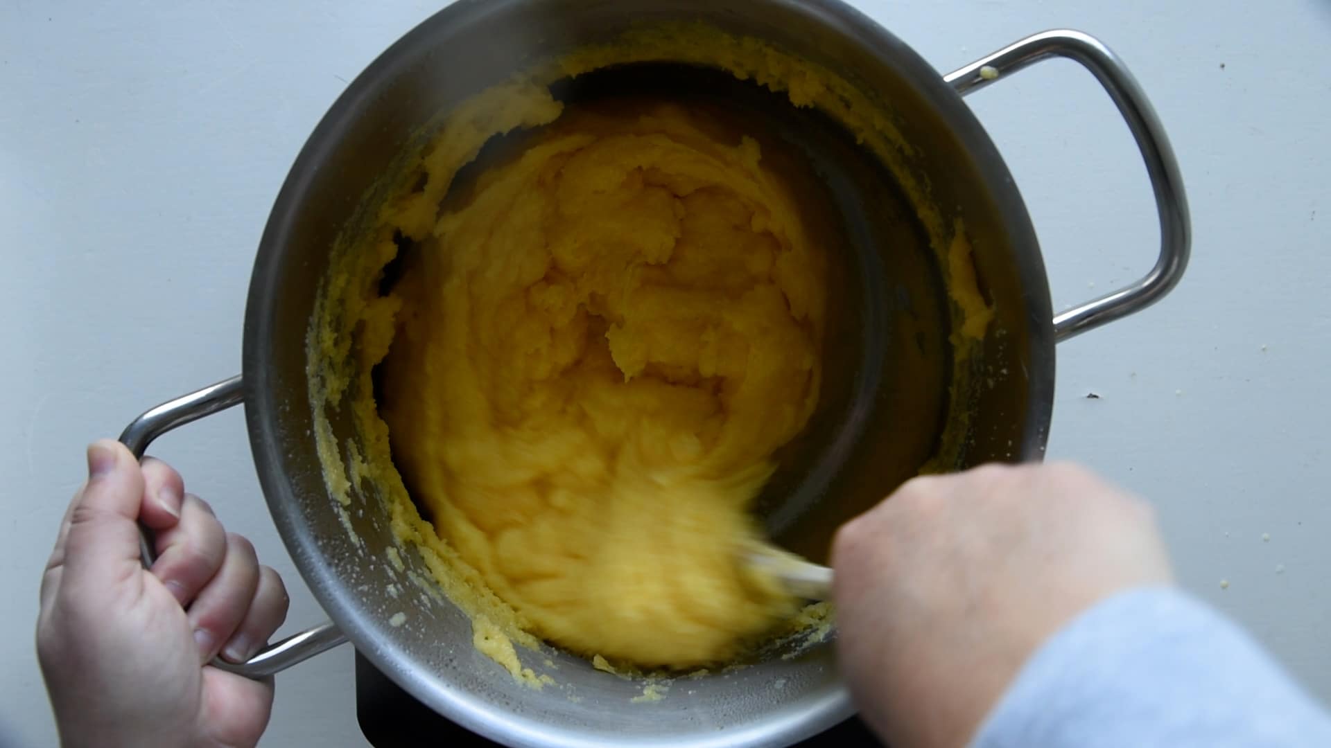 The polenta is done when the mixture pulls away cleanly from the pot walls.