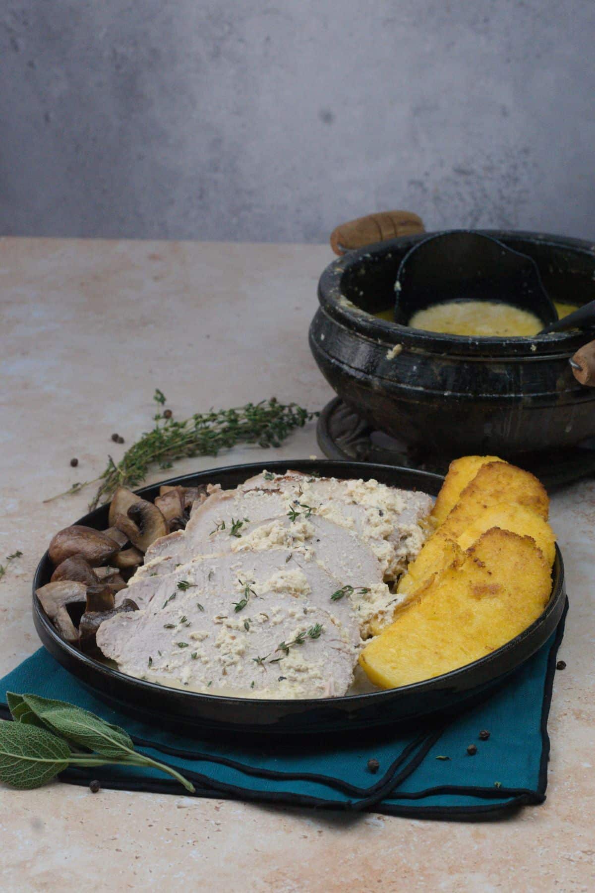 Pork cooked in milk served with polenta and mushrooms