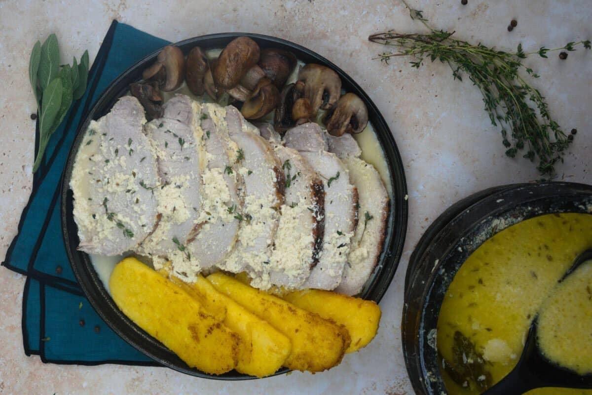 Pork cooked in milk served with polenta and mushrooms 